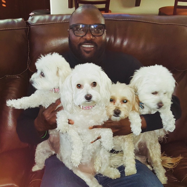 Victor holding four beautiful dogs